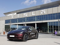 A Tesla Model y car stands in front of the company's plant as Tesla CEO Elon Musk visits the company...
