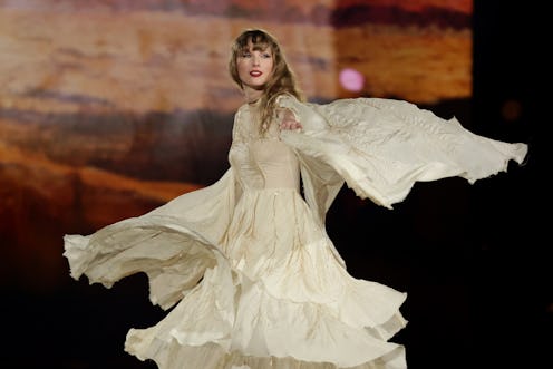 Taylor Swift performs during "Taylor Swift | The Eras Tour" in singapore in a white dress