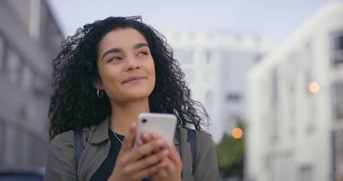 City, thinking and woman with a smartphone, smile and typing with connection and decision. New York,...