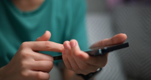 Selective focus, hands of woman holding smartphone for checking work or make appointment and using a...