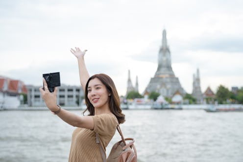 Asian travel blogger city sightseeing at Bangkok, Thailand, influencer or content creator, youtuber