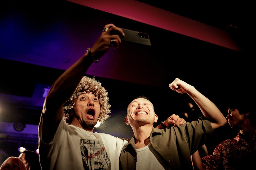 The two men are gutted and making funny faces with big smiles on their faces.