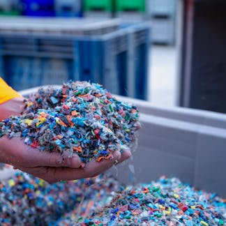 Plastic Resin pellets in holding hands.