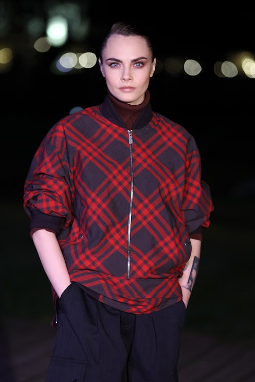 LONDON, ENGLAND - FEBRUARY 19: Cara Delevingne attends the Burberry show during London Fashion Week ...