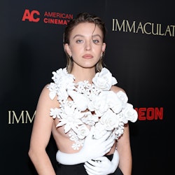 Sydney Sweeney wears a sculptural Balmain top with 3D flowers and hand to attend the premiere of "Im...