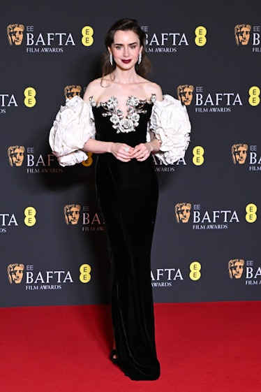Lily Collins poses in the winners room at the 2024 EE BAFTA Film Awards