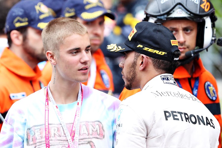 MONTE-CARLO, MONACO - MAY 29: Lewis Hamilton of Great Britain and Mercedes GP talks to singer Justin...
