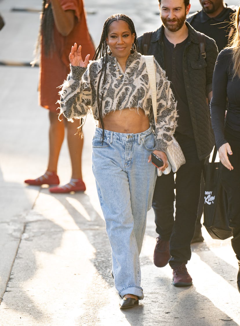 Regina King low-waisted jeans and distressed Louis Vuitton cropped sweater