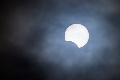 BEDFORD, INDIANA - OCTOBER 14: A partial solar eclipse is seen through clouds in Lawrence County Ind...