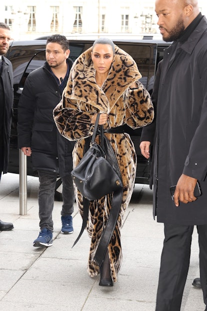 Who made Kim Kardashian's black jacket, capri pants, and gray sneakers in  2024
