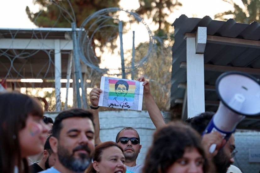 A participant holds up a silhouette picture depicting the late Egyptian LGBTQI activist Sarah Hegazi...