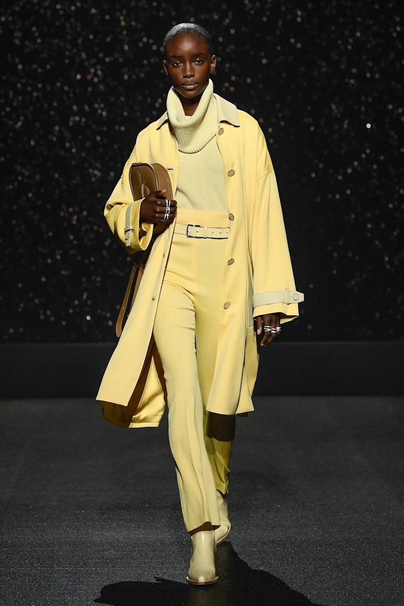Model on the rainy runway at Hermès RTW Fall 2024 as part of Paris Ready to Wear Fashion Week