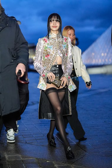 PARIS, FRANCE - MARCH 05: Lisa / Lalisa Manobal wears a floral print colored long jacket , black lea...