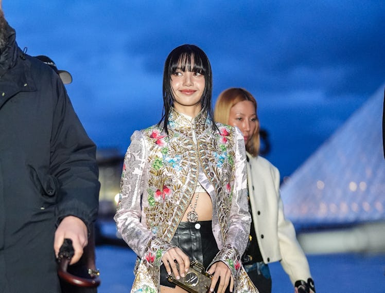 PARIS, FRANCE - MARCH 05: Lisa / Lalisa Manobal wears a floral print colored long jacket , black lea...