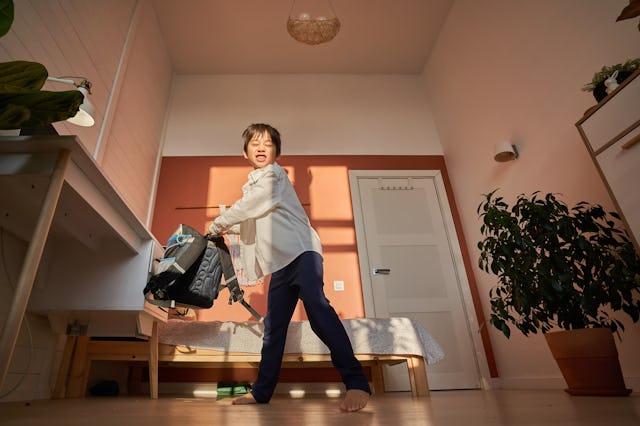 The boy swings his backpack to throw it. The end of the school year, finally the holidays.