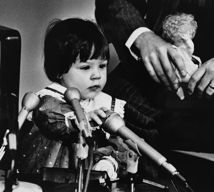 Elizabeth Jordan Carr plays with the microphones during a news conference.  She and her parents, Jud...
