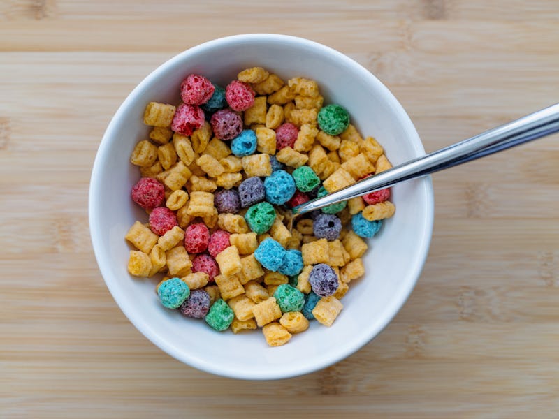 High angle view of a bowl of sweetened corn and oat breakfast cereal with fruit-flavored bits