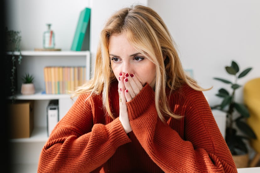 Worried young adult woman receiving online bad news. Millennial girl feeling shocked with hands on h...