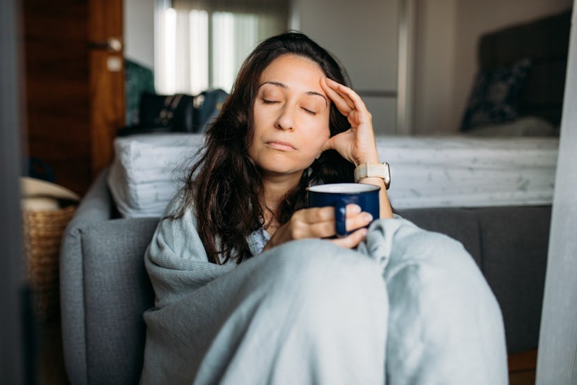 Woman suffering from stress sitting on the floor