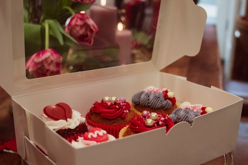 Cakes and flowers made for Valentine's Day in red, pink and purple colours , frostings and sprinkles...