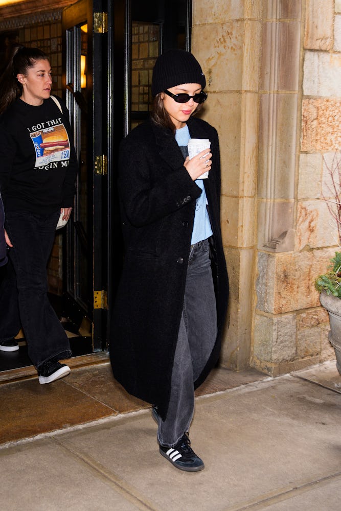 Olivia Rodrigo black jeans, Adidas sambas, and coat outfit
