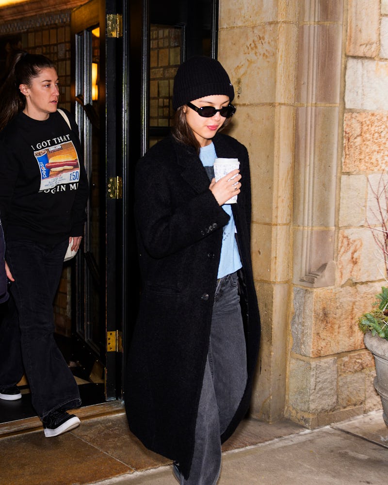 Olivia Rodrigo black jeans, Adidas sambas, and coat outfit