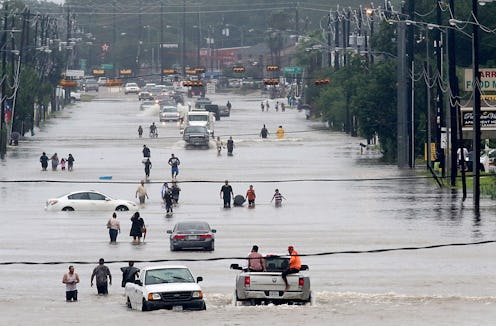 TOPSHOT - People walk through the flooded waters of Telephone Rd. in Houston on August 27, 2017 as t...
