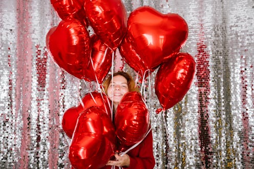 woman photoshoot with heart balloons