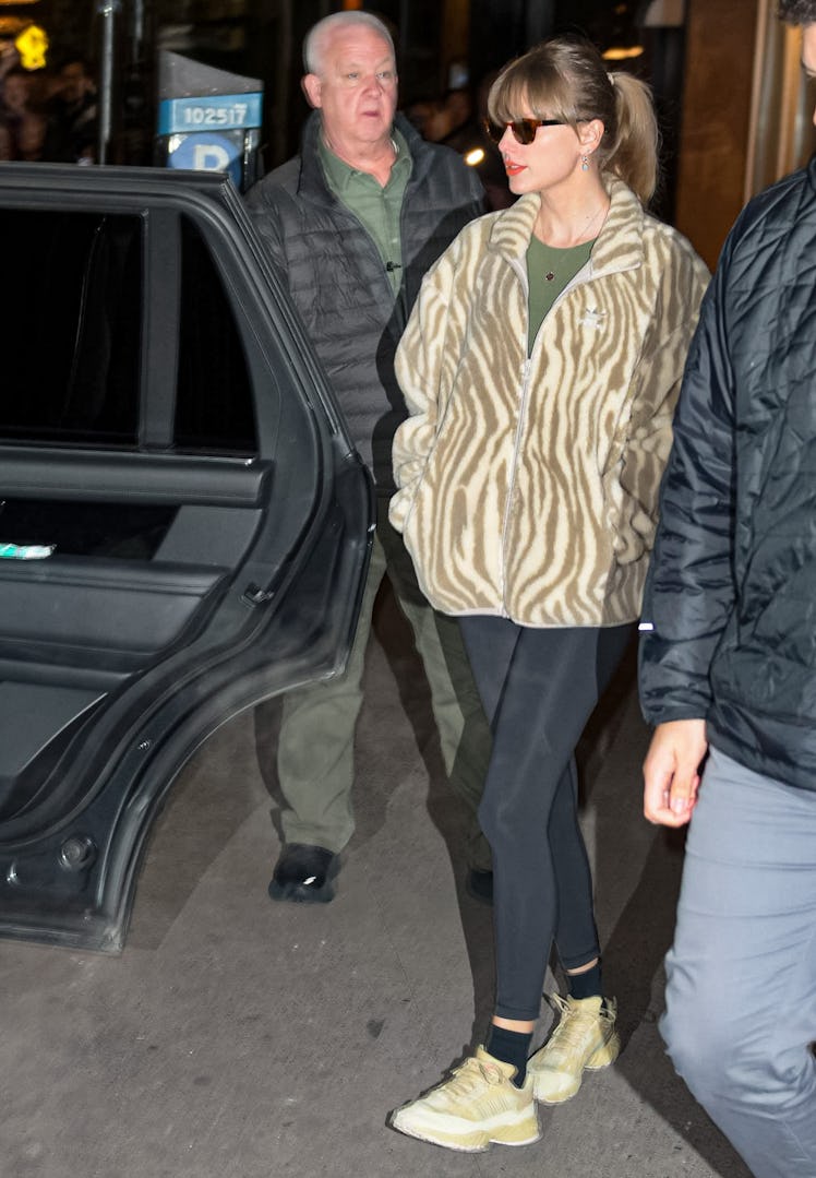 Taylor Swift kept it casual in a green tee and flannel jacket in NYC. 