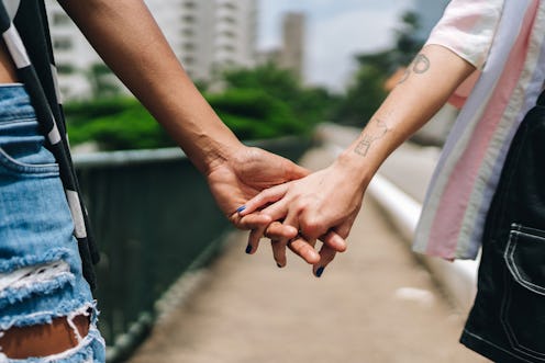 Close-up of a lesbian couple holding hands outdoors