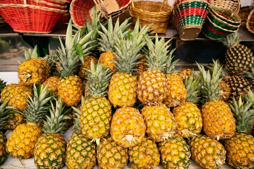 Close-up on pineapples in the produce aisle at the supermarket