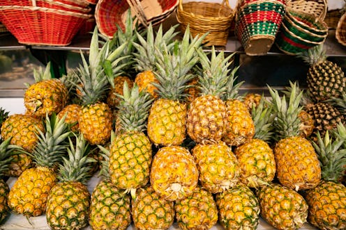 Close-up on pineapples in the produce aisle at the supermarket