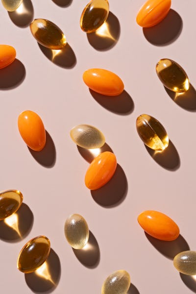 Various of Soft Gel Capsule Pills on Beige Background High Angle View.