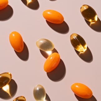 Various of Soft Gel Capsule Pills on Beige Background High Angle View.