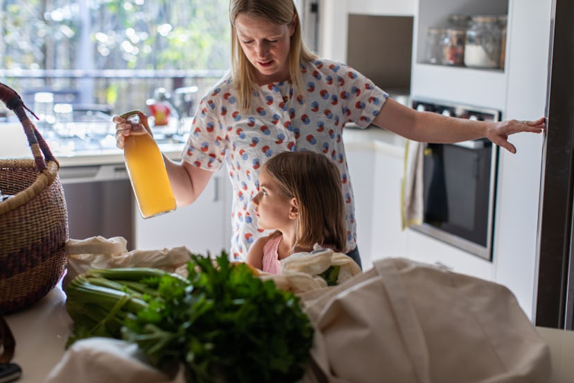 Mom and daughter chat while putting groceries into the fridge, in a story answering the question 'ca...