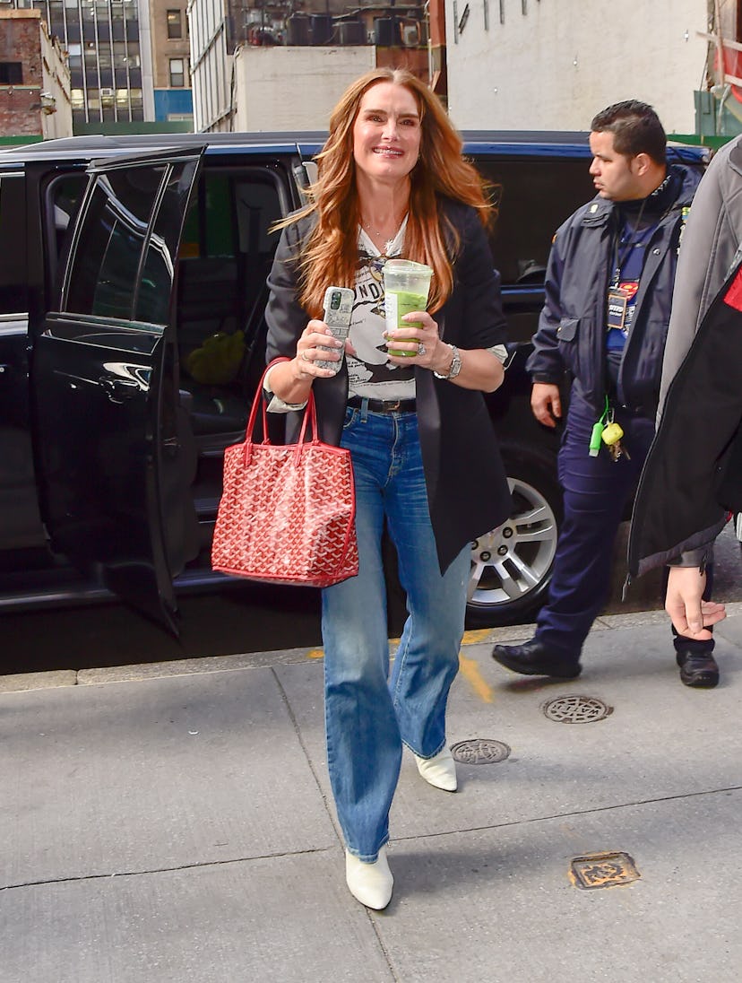 Brooke Shields carries a red Goyard Saint Louis in Midtown on April 04, 2023 in New York City. 