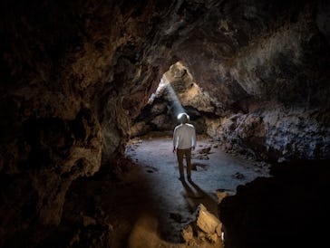 SAN BERNARDINO COUNTY, CA - APRIL 01: A shaft of light illuminates the Lava Tube, formed long ago by...