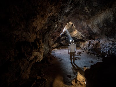 SAN BERNARDINO COUNTY, CA - APRIL 01: A shaft of light illuminates the Lava Tube, formed long ago by...