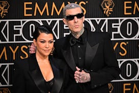 US socialite Kourtney Kardashian and husband US musician Travis Barker arrive for the 75th Emmy Awar...