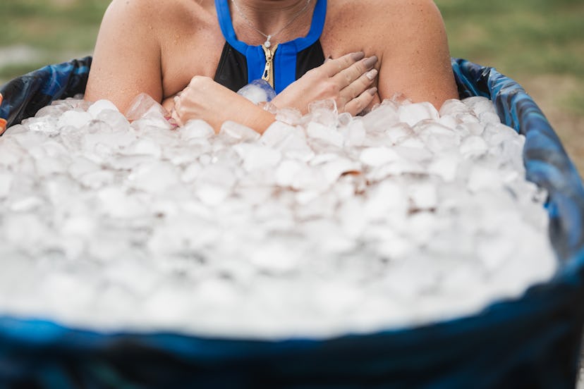 Woman with her arms folded in an ice bath, in a story about whether it's safe or not to cold plunge ...