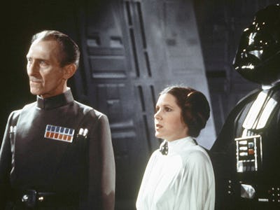 British actors Peter Cushing, David Prowse, and American actress Carrie Fisher on the set of Star Wa...