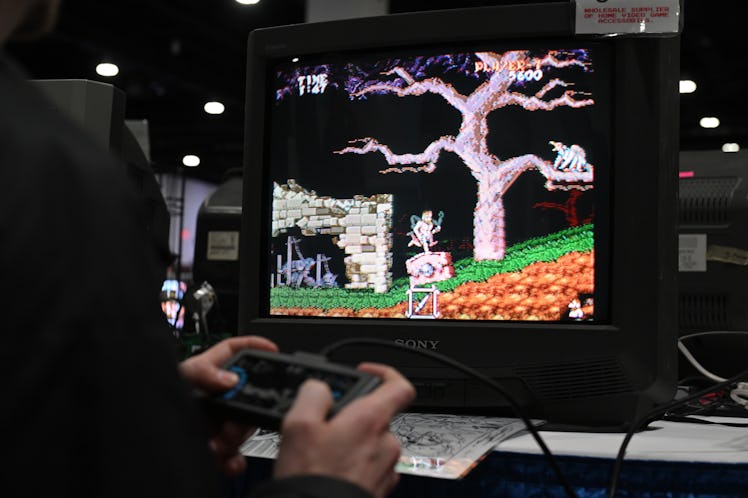 MILWAUKEE, WISCONSIN - APRIL 06: An attendee plays a retro video game during the Midwest Gaming Clas...