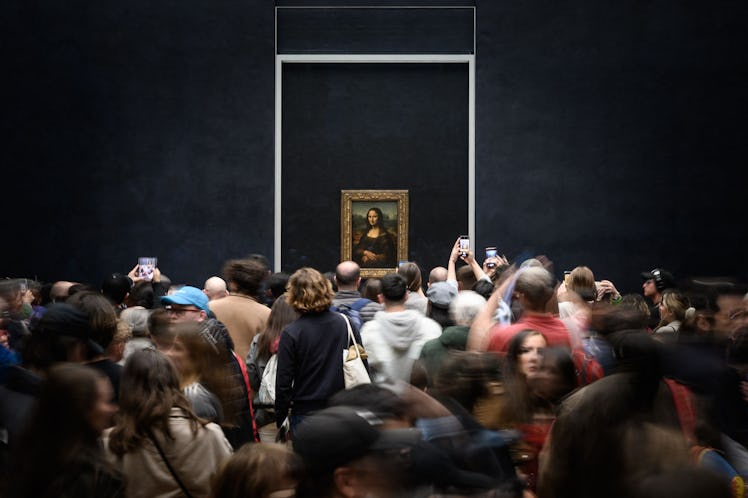 Visitors take picture of the painting "La Joconde" The Mona Lisa by Italian artist Leonardo Da Vinci...