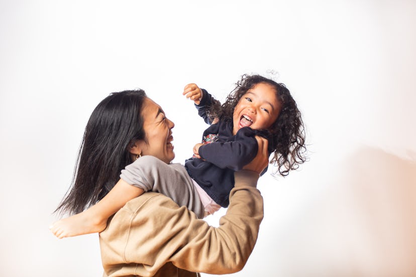 mom and daughter have fun together with a white background, in a story about mother's day gifts for ...