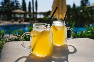 Lynchburg lemonade cocktail glasses standing on the sun lounger.