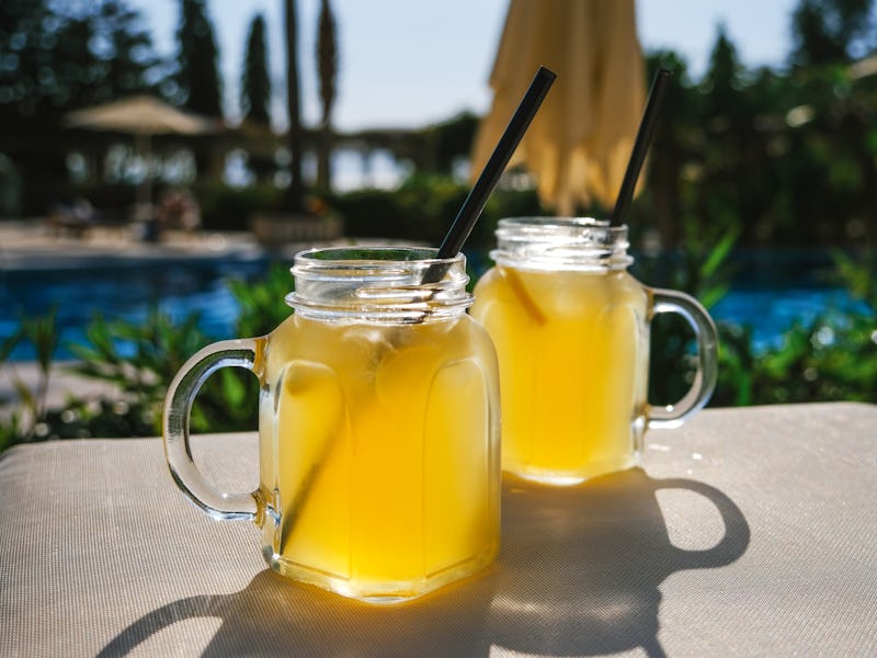 Lynchburg lemonade cocktail glasses standing on the sun lounger.
