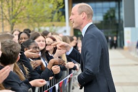 BIRMINGHAM, ENGLAND - APRIL 25: Prince William, Prince of Wales is greeted by school children upon h...
