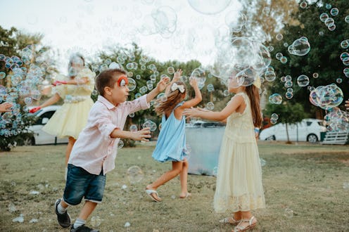 Little Girls at foam birthday party Foam party at home yard with lot of shampoo for fun