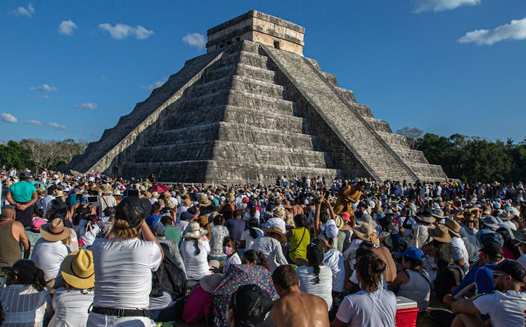 People surround the Kukulcan Pyramid at the Mayan archaeological site of Chichen Itza in Yucatan Sta...