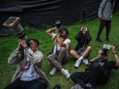 BOGOTA, COLOMBIA - OCTOBER 14: Photographers take pictures during an annular solar eclipse at Planet...